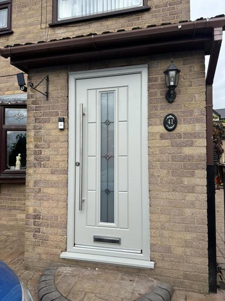 Cream composite door in a porch fitted by Bleaklow Windows